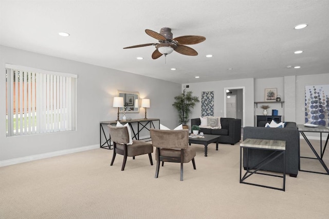 living area with light colored carpet, recessed lighting, baseboards, and a ceiling fan