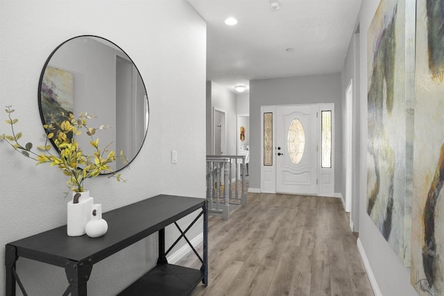 entryway with baseboards and light wood-type flooring
