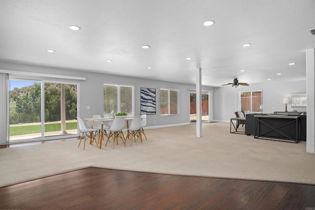 interior space featuring light carpet, baseboards, ceiling fan, recessed lighting, and light wood finished floors