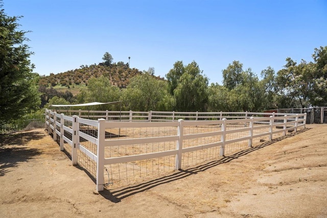 view of yard featuring a rural view and fence