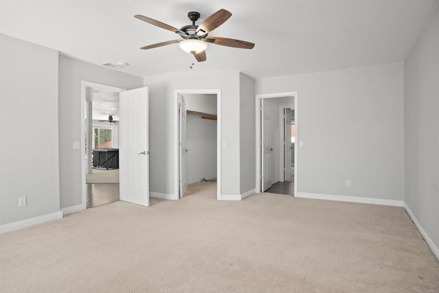 unfurnished bedroom featuring baseboards, a ceiling fan, and light carpet