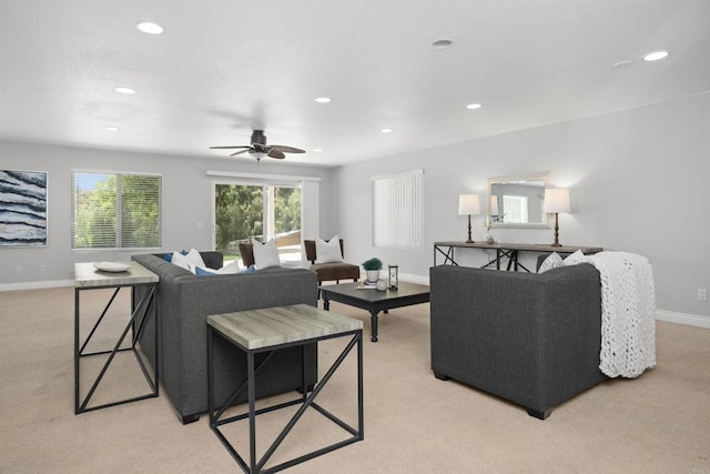living area featuring recessed lighting, a ceiling fan, light carpet, and baseboards