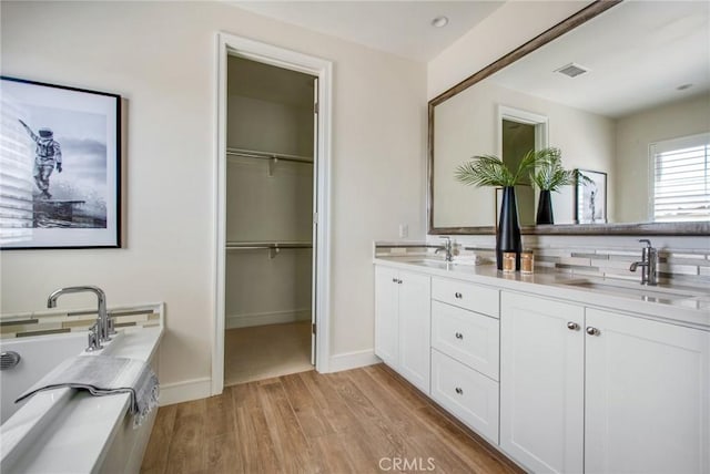 118 Tritone, Irvine, CA 92602 - bathroom with a sink, double vanity, visible vents, and wood finished floors