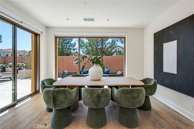 118 Tritone, Irvine, CA 92602 - dining space with light wood-type flooring, visible vents, and a healthy amount of sunlight