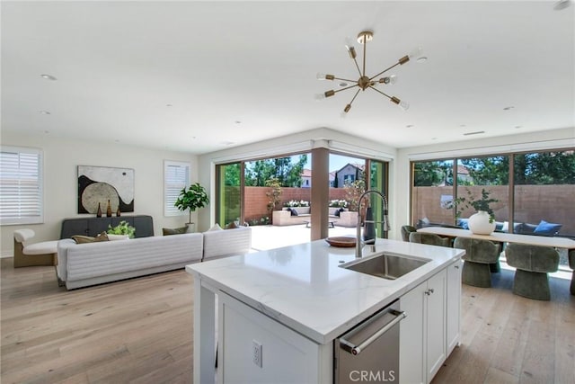 118 Tritone, Irvine, CA 92602 - kitchen featuring light wood finished floors, a wealth of natural light, open floor plan, and a sink