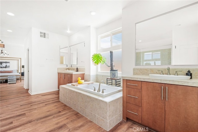 4934 Herzog Way, Palm Springs, CA 92262 - full bathroom with wood finished floors, two vanities, a garden tub, and recessed lighting