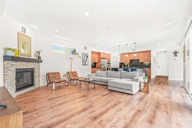 4934 Herzog Way, Palm Springs, CA 92262 - living area with light wood-style floors, a fireplace, and recessed lighting
