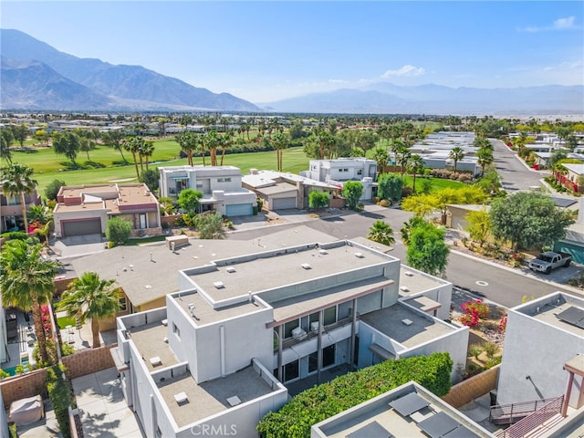 aerial view of residential area with a mountain backdrop and a local golf course