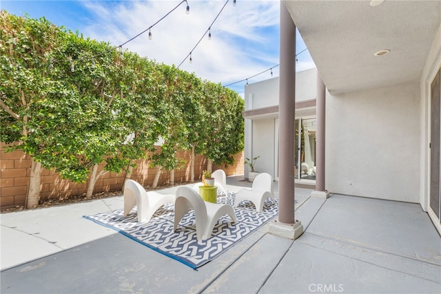 view of patio featuring fence