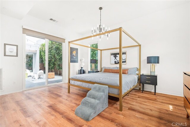 4934 Herzog Way, Palm Springs, CA 92262 - bedroom featuring access to exterior, wood finished floors, and a chandelier