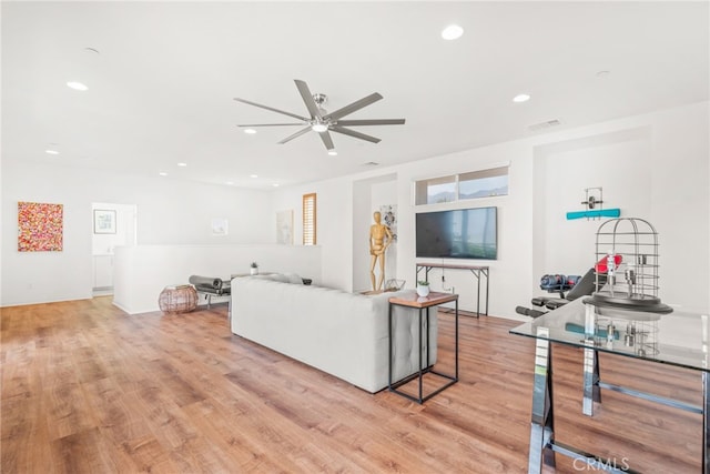 living area featuring ceiling fan, recessed lighting, and light wood-style floors