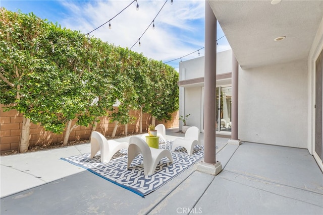 view of patio featuring fence