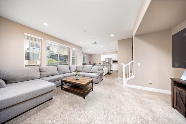 living area featuring baseboards, light carpet, recessed lighting, and visible vents