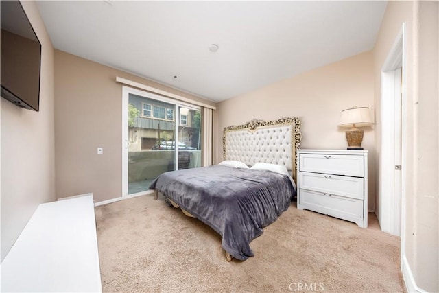 carpeted bedroom with access to outside and baseboards