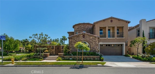 mediterranean / spanish home featuring a garage, driveway, a balcony, and stucco siding