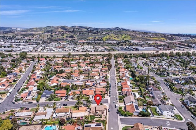 drone / aerial view featuring a residential view and a mountain view