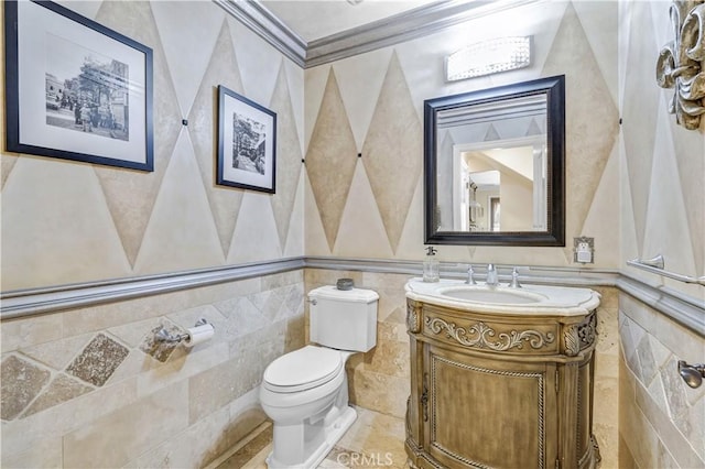 bathroom with crown molding, tile walls, vanity, and toilet