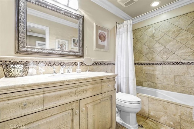 bathroom featuring crown molding, tile patterned flooring, vanity, toilet, and tile walls