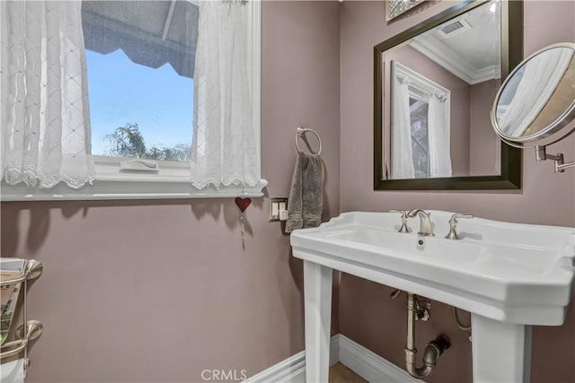 bathroom with crown molding, baseboards, and visible vents