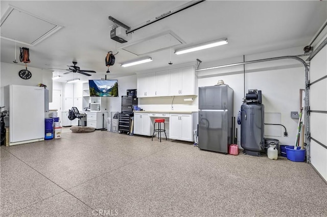 garage featuring freestanding refrigerator and a ceiling fan