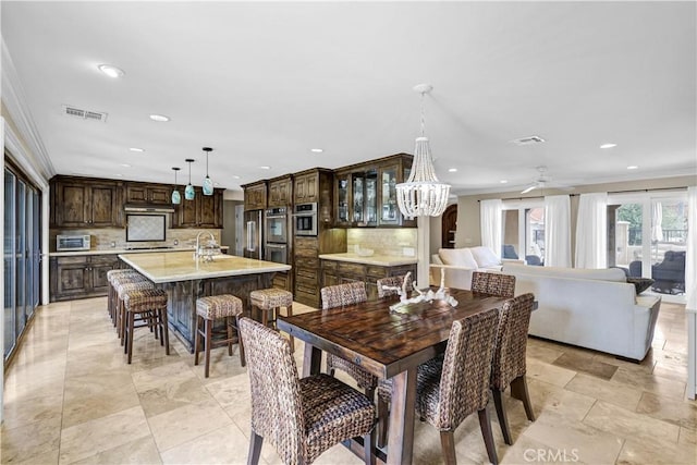 dining room featuring visible vents, recessed lighting, ceiling fan with notable chandelier, and ornamental molding