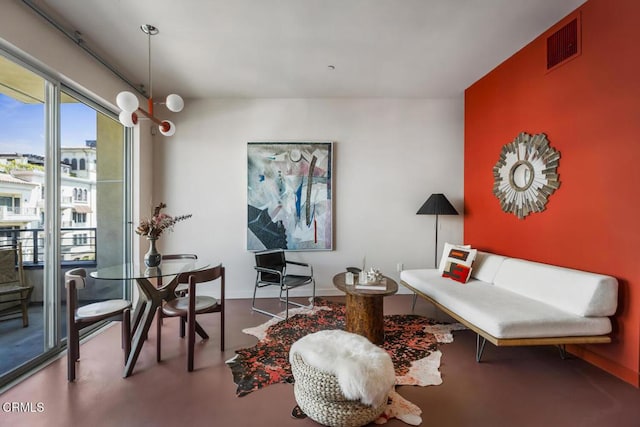 living area featuring baseboards and visible vents