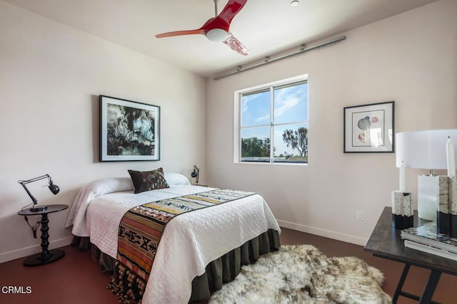 bedroom featuring baseboards and a ceiling fan