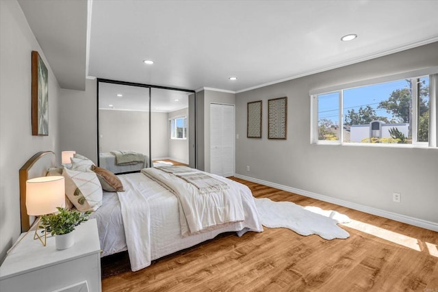 bedroom with baseboards, recessed lighting, and wood finished floors