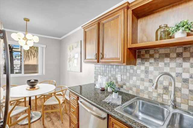 kitchen featuring brown cabinetry, backsplash, stainless steel dishwasher, wood finished floors, and a sink