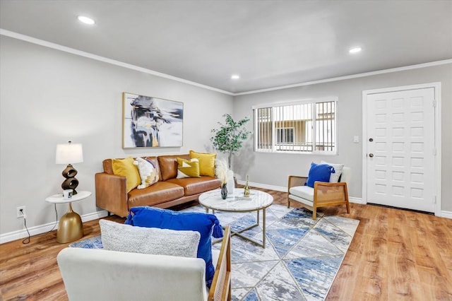 living room featuring crown molding, baseboards, recessed lighting, and wood finished floors