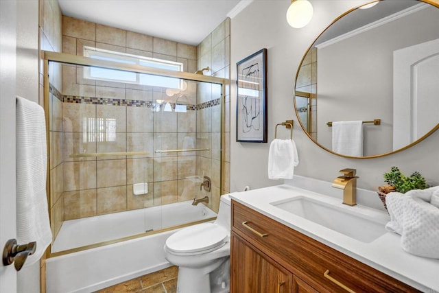bathroom featuring vanity, enclosed tub / shower combo, crown molding, and toilet