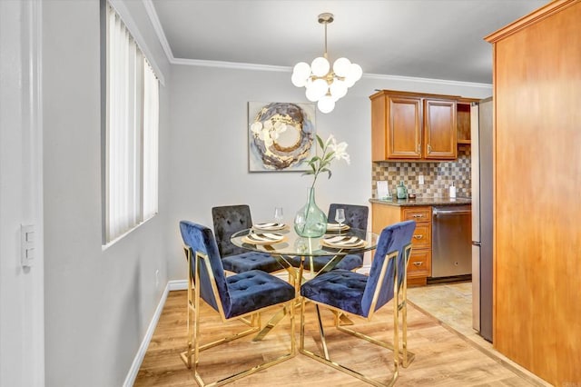 dining room with an inviting chandelier, ornamental molding, baseboards, light wood-type flooring, and a wealth of natural light