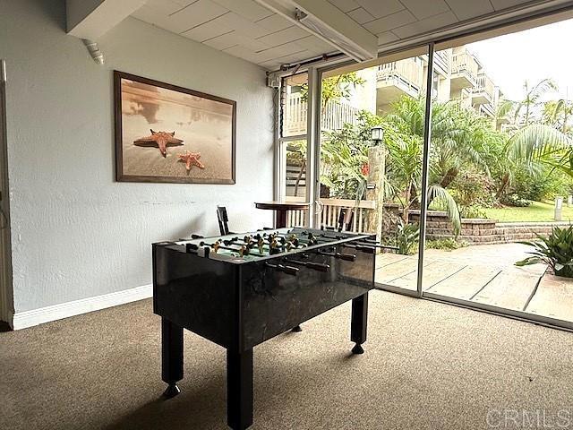 recreation room featuring carpet floors and baseboards