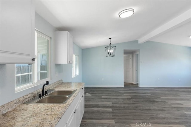 108 2nd St, Taft, CA 93268 - kitchen with white cabinetry, a chandelier, dark wood-style floors, light countertops, and pendant lighting