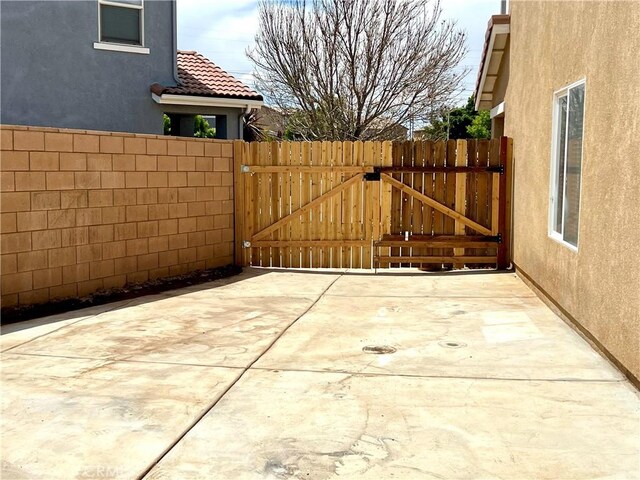 view of patio / terrace with fence and a gate