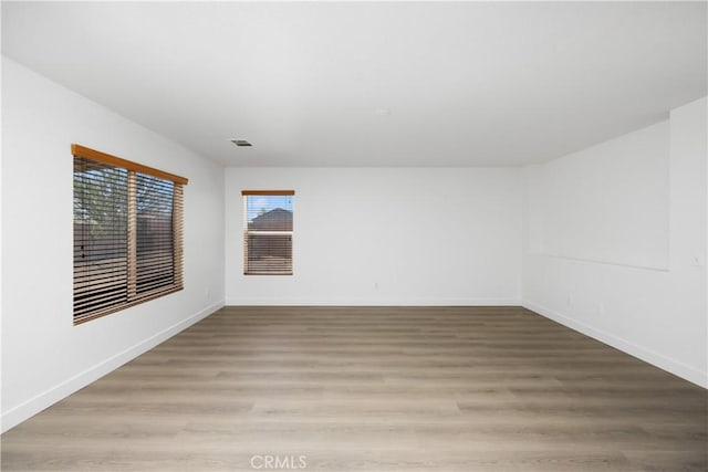 9331 Sapphire Ave, Hesperia, CA 92344 - empty room with baseboards and light wood-style flooring
