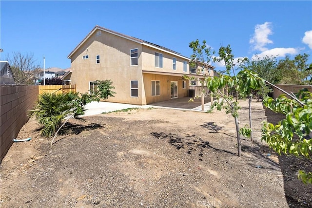 9331 Sapphire Ave, Hesperia, CA 92344 - rear view of property featuring a fenced backyard, stucco siding, and a patio area