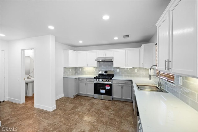 9331 Sapphire Ave, Hesperia, CA 92344 - kitchen featuring stainless steel range with gas stovetop, a sink, tasteful backsplash, light countertops, and recessed lighting