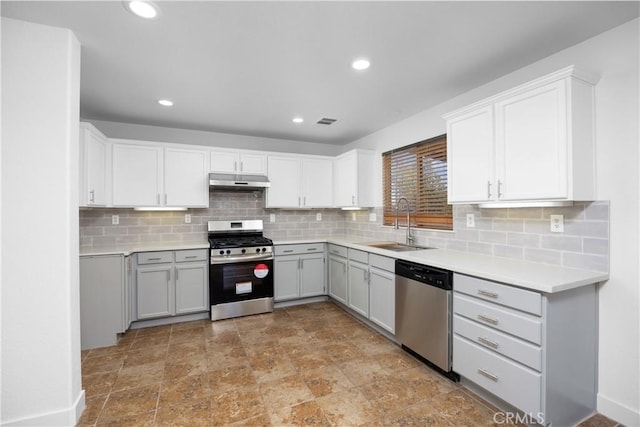 9331 Sapphire Ave, Hesperia, CA 92344 - kitchen featuring stainless steel appliances, under cabinet range hood, a sink, tasteful backsplash, and light countertops