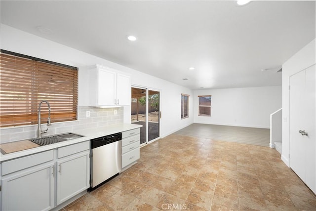 9331 Sapphire Ave, Hesperia, CA 92344 - kitchen with stainless steel dishwasher, a sink, light countertops, backsplash, and baseboards