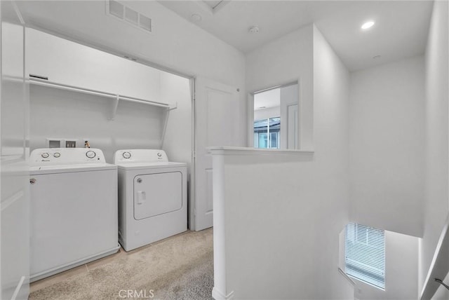 washroom with visible vents, laundry area, washing machine and dryer, and recessed lighting