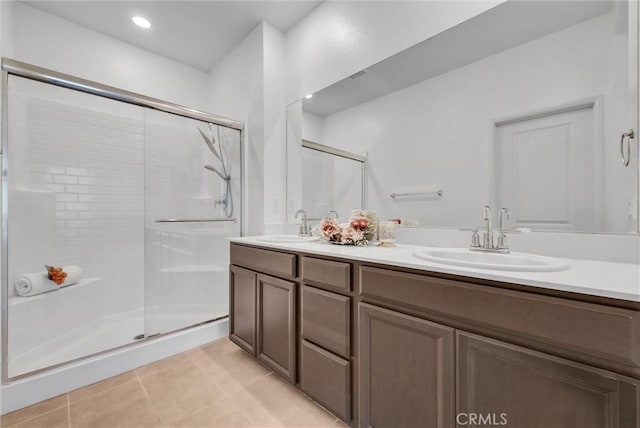 full bathroom with tile patterned flooring, a sink, and a stall shower