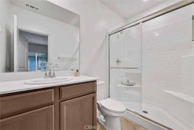 full bathroom with vanity, a stall shower, toilet, and visible vents