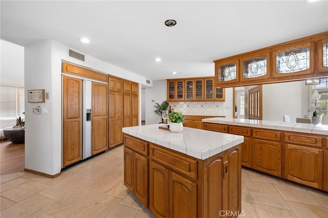 10703 Wheatland Ave, Sunland, CA 91040 - kitchen featuring visible vents, tile countertops, recessed lighting, and tasteful backsplash