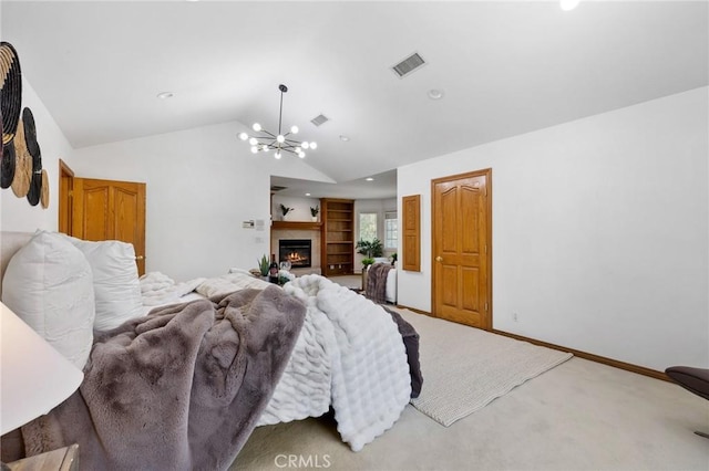 10703 Wheatland Ave, Sunland, CA 91040 - bedroom with visible vents, a glass covered fireplace, lofted ceiling, an inviting chandelier, and carpet flooring