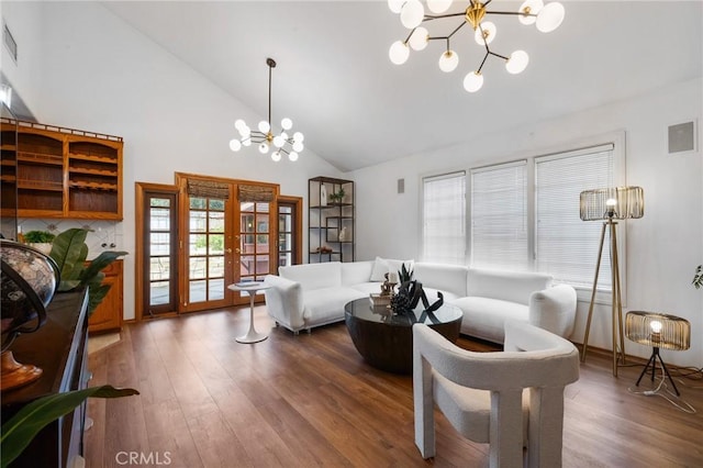 10703 Wheatland Ave, Sunland, CA 91040 - living area featuring french doors, wood finished floors, a notable chandelier, and high vaulted ceiling
