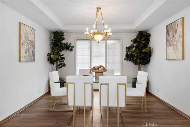 10703 Wheatland Ave, Sunland, CA 91040 - dining area with a tray ceiling, wood finished floors, and a notable chandelier