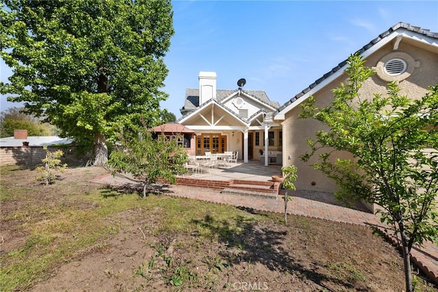 10703 Wheatland Ave, Sunland, CA 91040 - back of property featuring a chimney, a patio area, and stucco siding