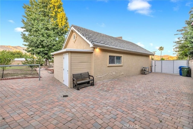 10703 Wheatland Ave, Sunland, CA 91040 - rear view of house featuring a gate, a patio area, stucco siding, and fence