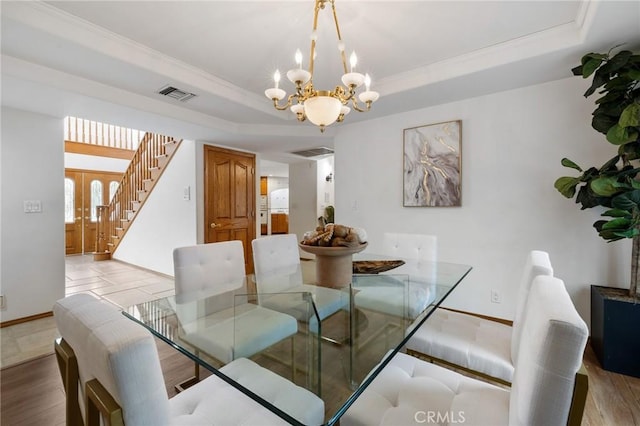 10703 Wheatland Ave, Sunland, CA 91040 - dining room featuring visible vents, light wood-type flooring, stairway, a chandelier, and a tray ceiling